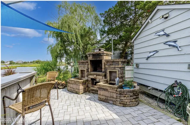 a view of backyard with outdoor seating and plants