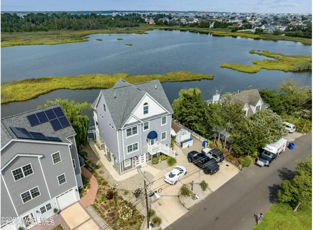 an aerial view of a house with a lake view