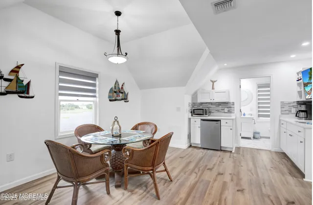 a dining room with furniture and window