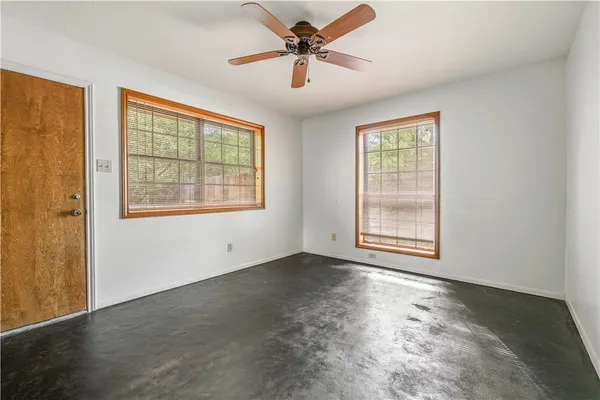 a view of a wooden deck with a bench and trees
