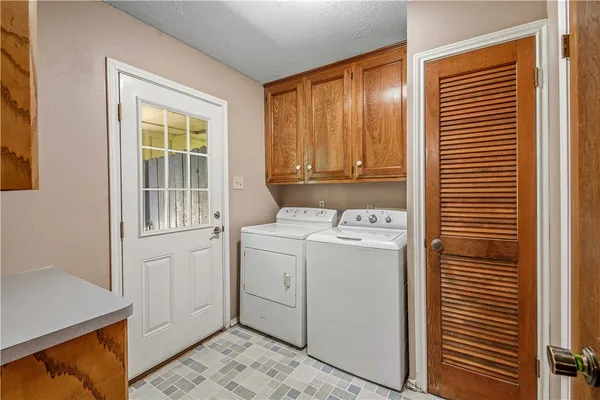 a living room with lots of furniture and kitchen view