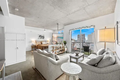 a living room with furniture ceiling fan and a rug