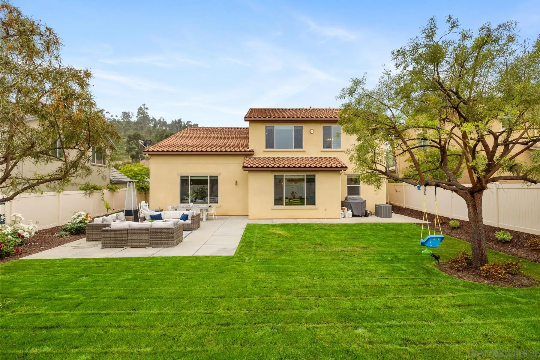 17519 Ralphs Ranch Road San Diego, CA 92127 - Photo 30 of 32 a front view of a house with garden and trees