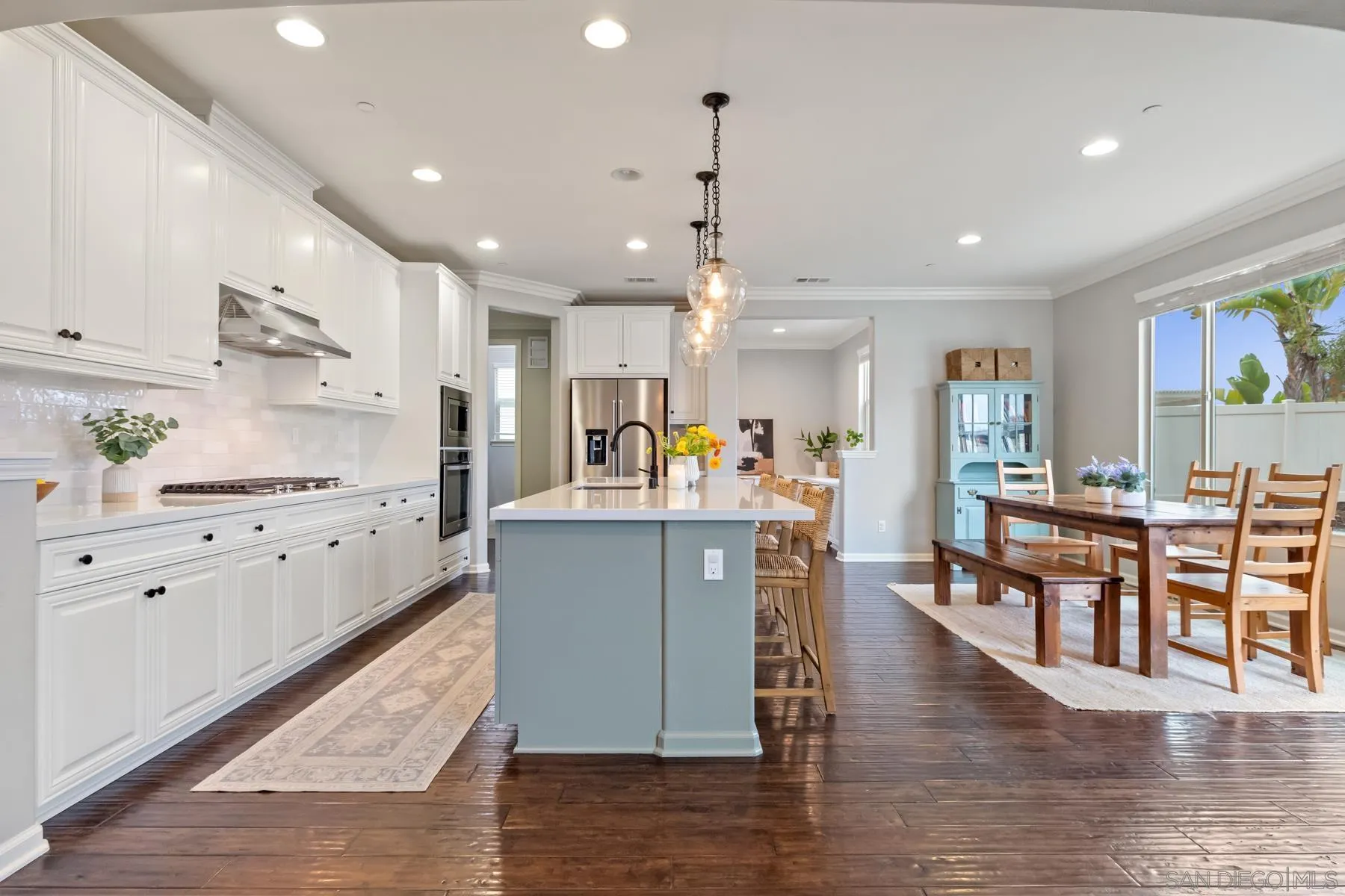 17519 Ralphs Ranch Road San Diego, CA 92127 - Photo 9 of 32 a large kitchen with cabinets chairs and wooden floor