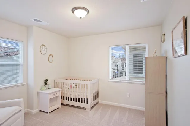 a spacious bedroom with a bed and a window