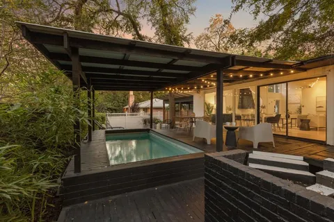 a view of a two chairs in the balcony
