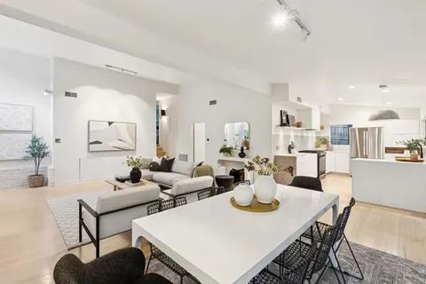 a view of a dining room with furniture and wooden floor