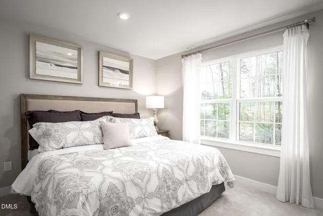 a spacious bedroom with a bed and a dresser