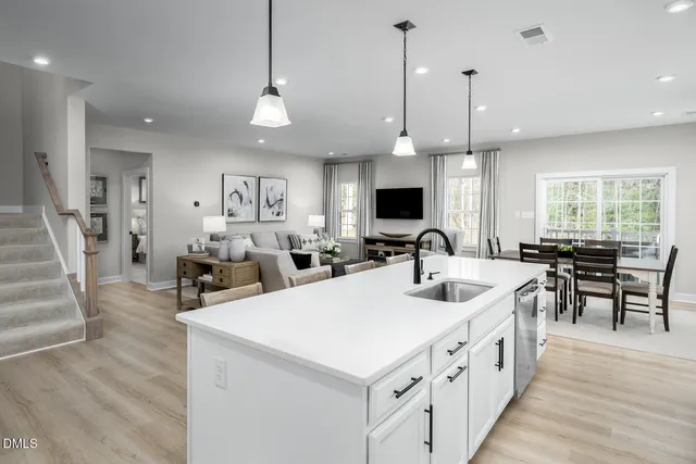 a kitchen with counter top space a sink stainless steel appliances and cabinets