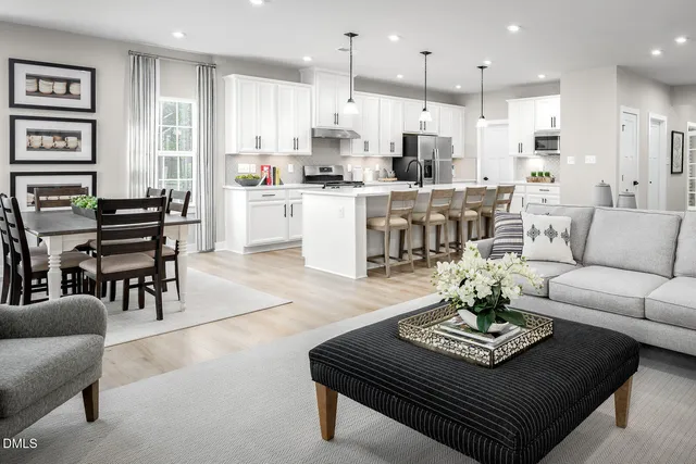 a living room with furniture kitchen and a table