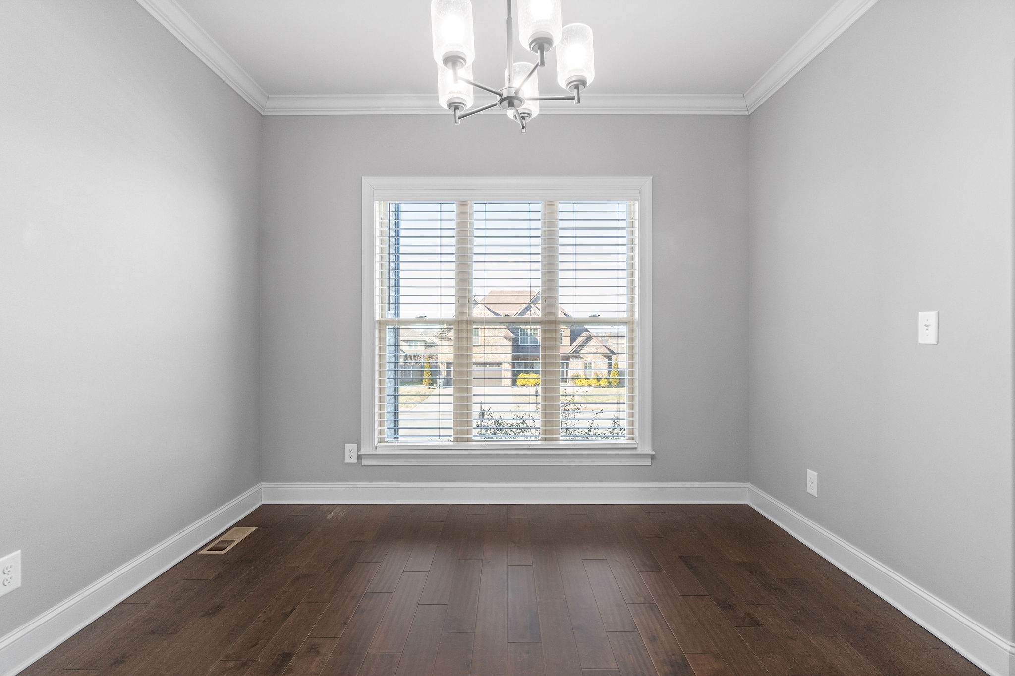 520 Larkspur Drive Clarksville, TN 37043 - Photo 4 of 34 an empty room with wooden floor chandelier fan and windows
