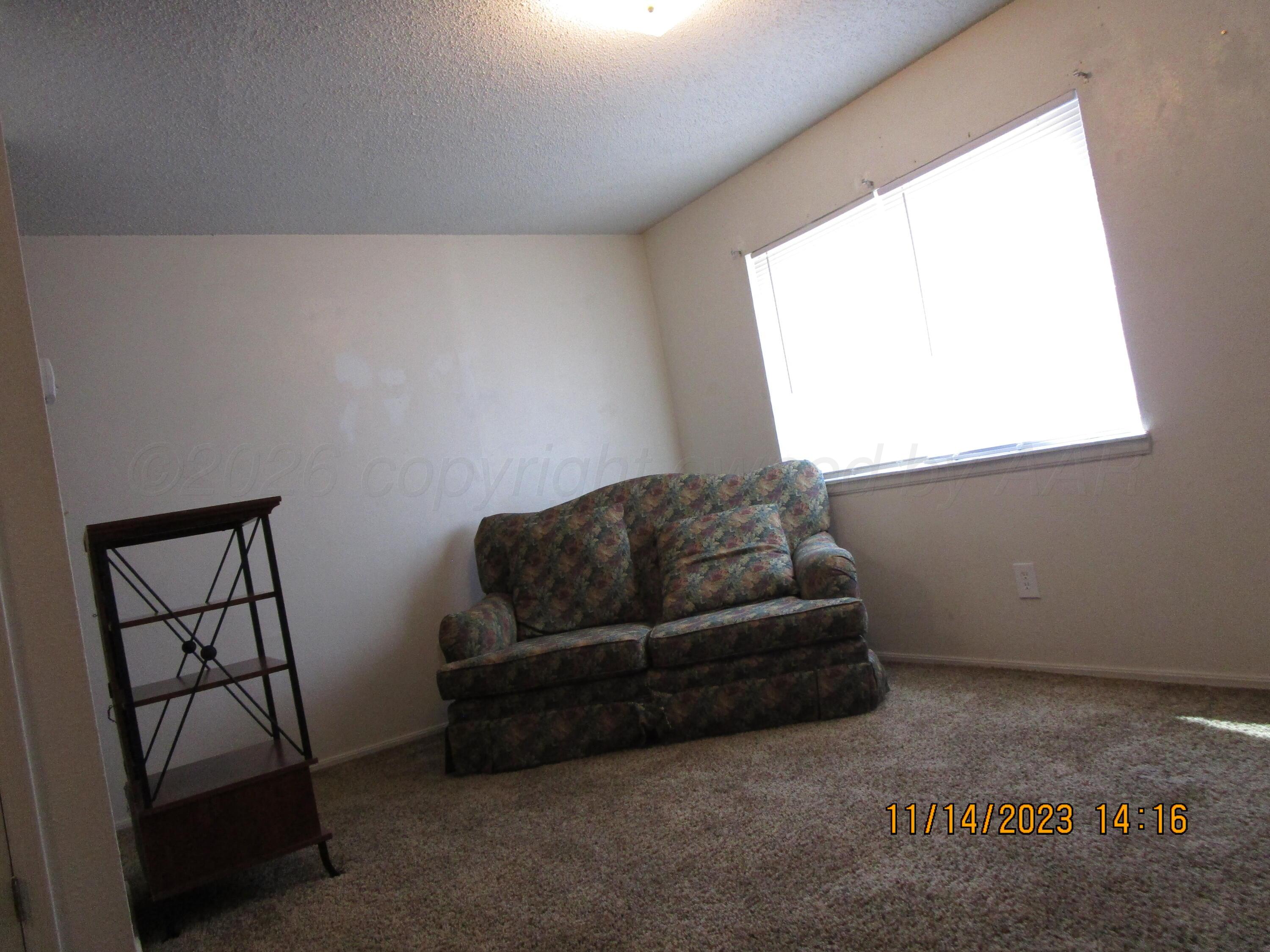 710 Deahl Street Borger, TX 79007 - Photo 2 of 5 a living room with a couch and a window