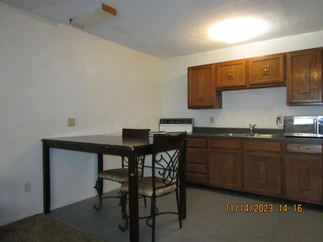 a kitchen with a table and chairs in it