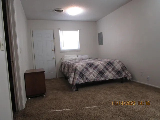 a bedroom with a bed and a window