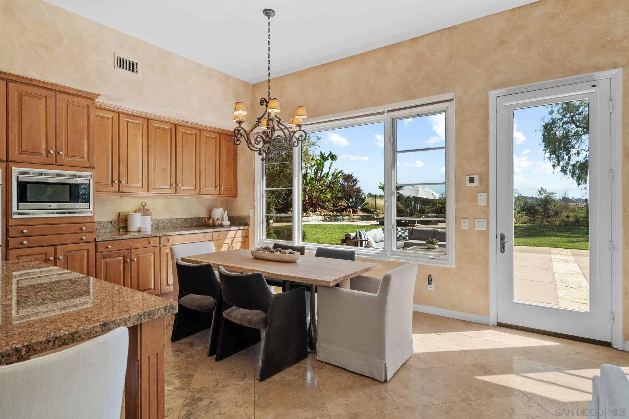 17813 La Amapola Rancho Santa Fe, CA 92067 - Photo 11 of 30 a room with kitchen island granite countertop a sink and a stove