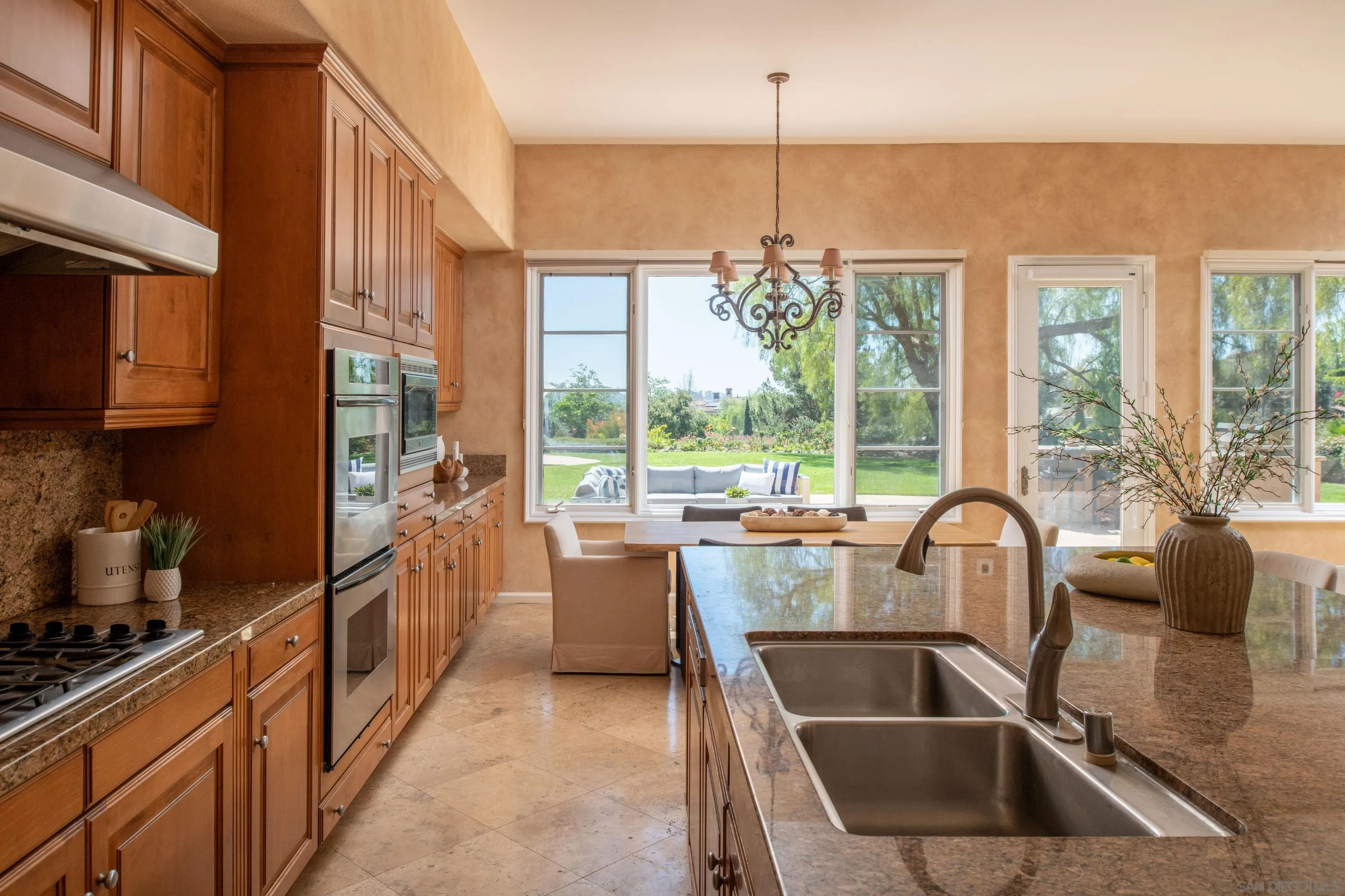 17813 La Amapola Rancho Santa Fe, CA 92067 - Photo 13 of 30 a kitchen with large windows sink and cabinets