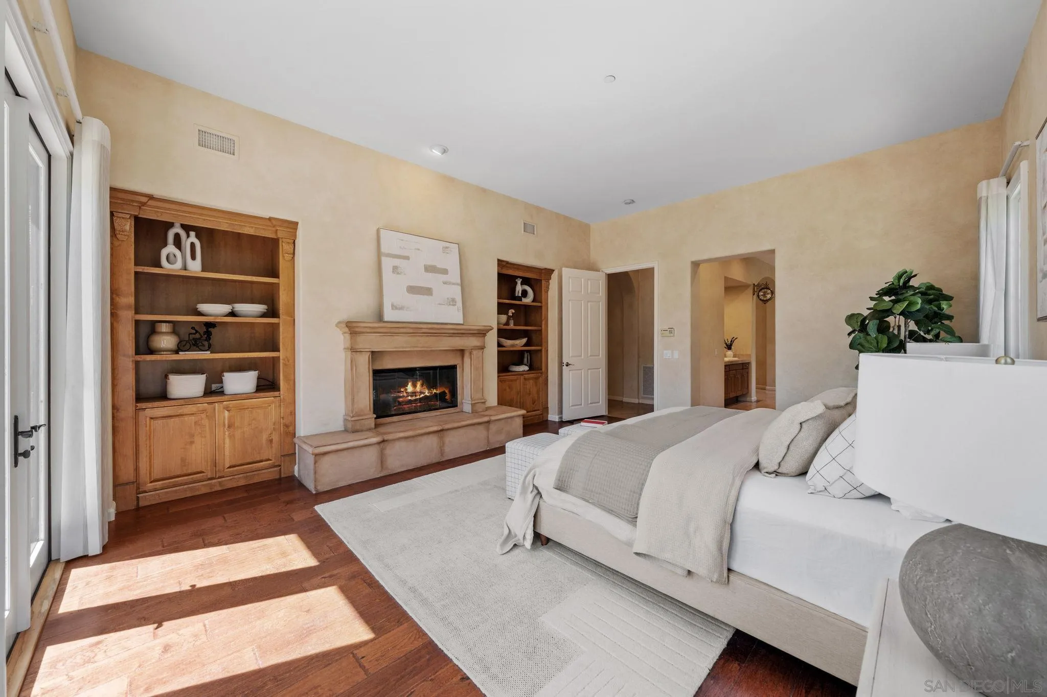 17813 La Amapola Rancho Santa Fe, CA 92067 - Photo 15 of 30 a bedroom with a large bed and a fireplace