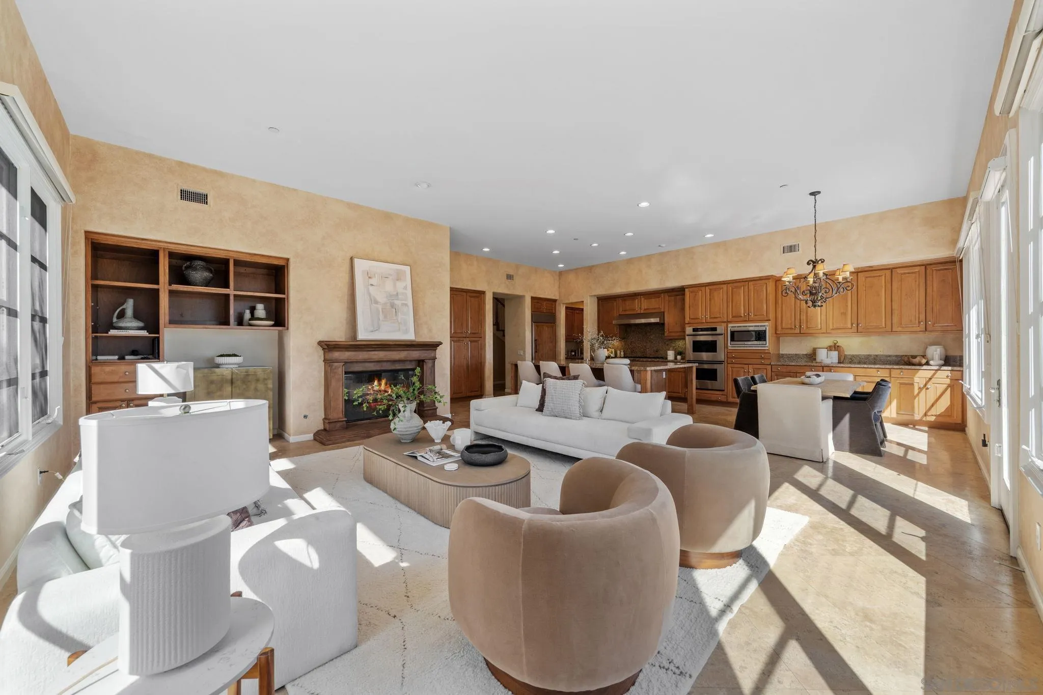 17813 La Amapola Rancho Santa Fe, CA 92067 - Photo 8 of 30 a living room with fireplace furniture and a view of kitchen