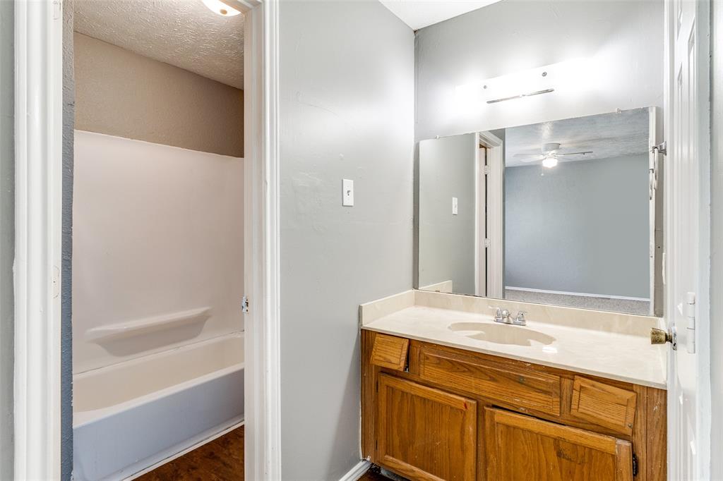 2354 Little Pocket Road, Unit B Dallas, TX 75228 - Photo 11 of 12 Bathroom featuring vanity, a textured ceiling, dark wood finished floors, and shower / bathtub combination