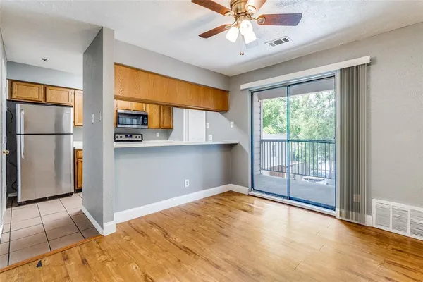 a view of a kitchen with a stove cabinets and a ceiling fan