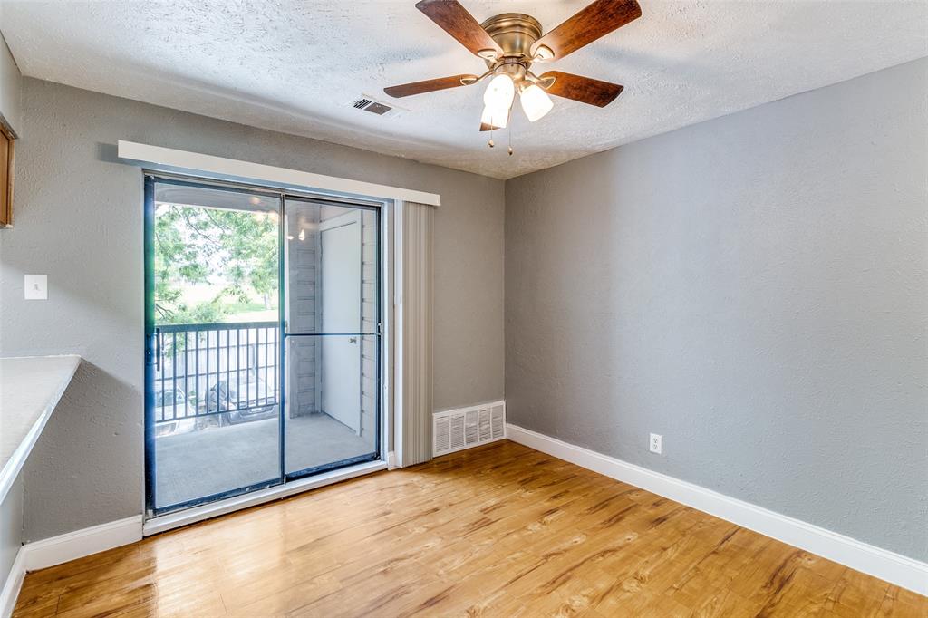 2354 Little Pocket Road, Unit B Dallas, TX 75228 - Photo 5 of 12 Spare room featuring a textured wall, ceiling fan, light wood-type flooring, and a textured ceiling