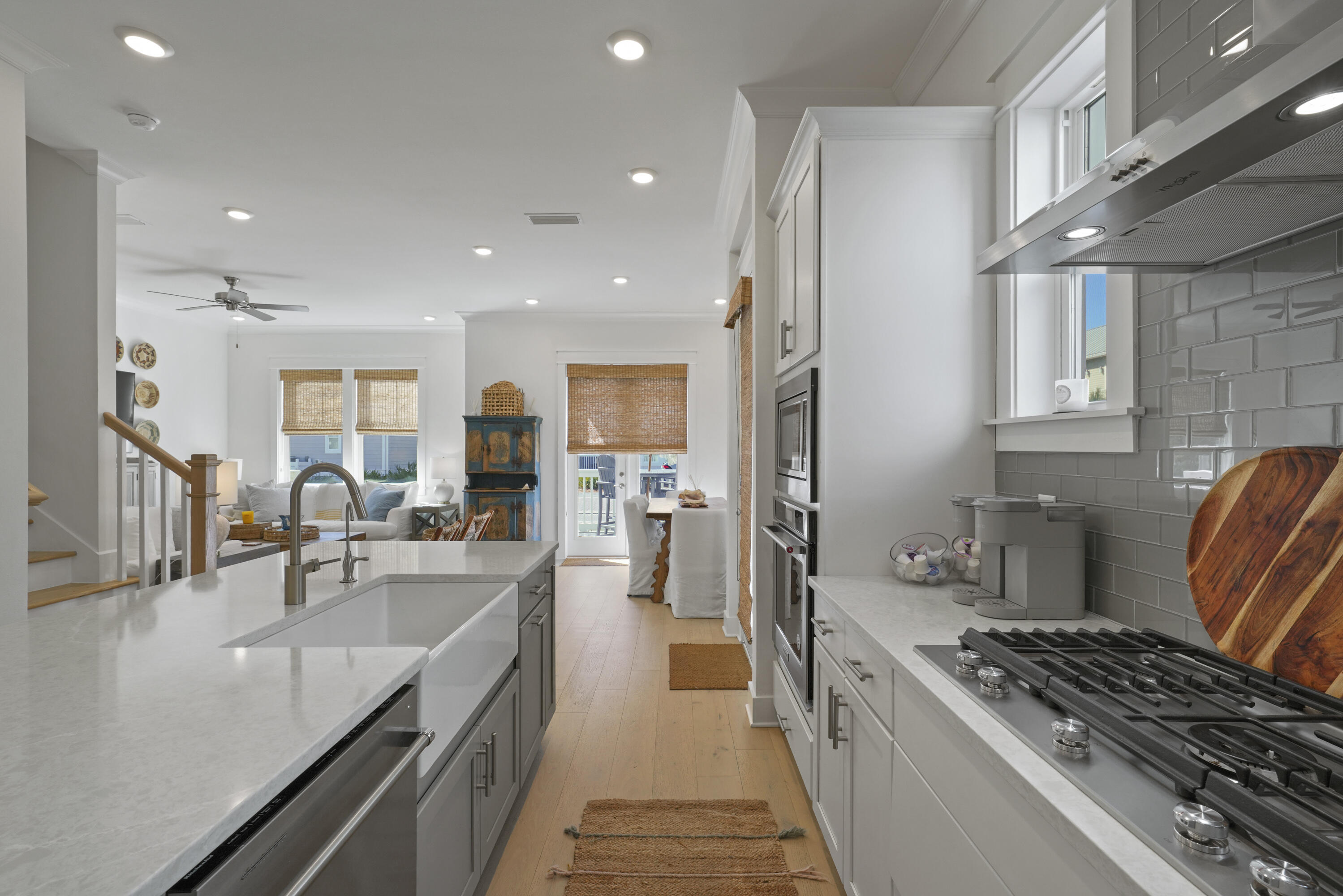 96 Wharf Ln Inlet Beach, Unit B Inlet Beach, FL 32461 - Photo 8 of 44 a kitchen with stainless steel appliances granite countertop a stove top oven a sink dishwasher a dining table and chairs with wooden floor