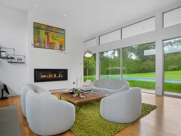 a living room with patio furniture and a fireplace