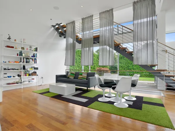 a living room with furniture and floor to ceiling windows