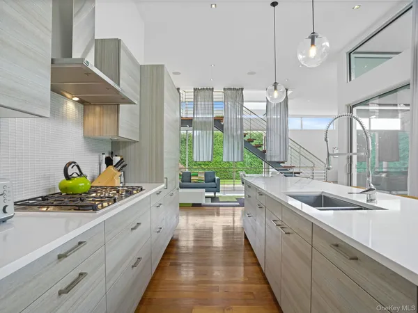 a large kitchen with a lot of white cabinets