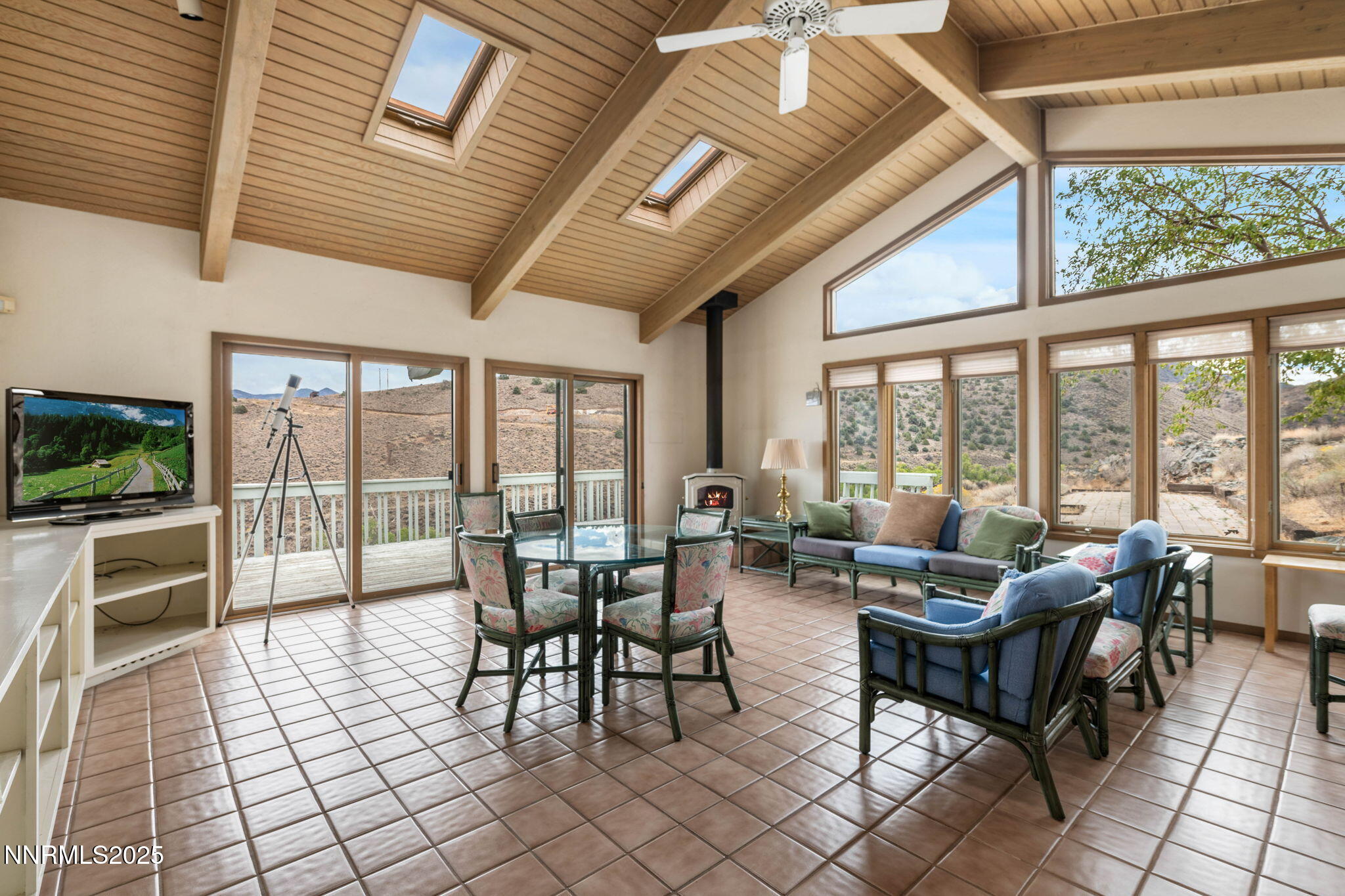 77 Ophir Mill Road Dayton, NV 89403 - Photo 16 of 44 a living room with furniture and a floor to ceiling window