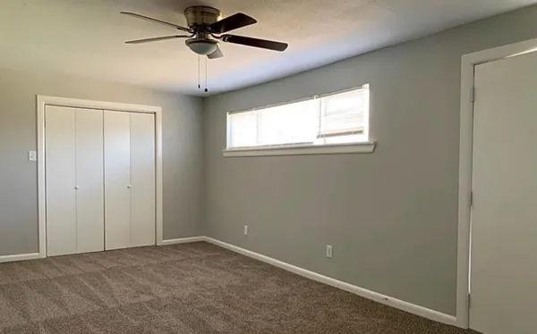 a view of a livingroom with a ceiling fan and window