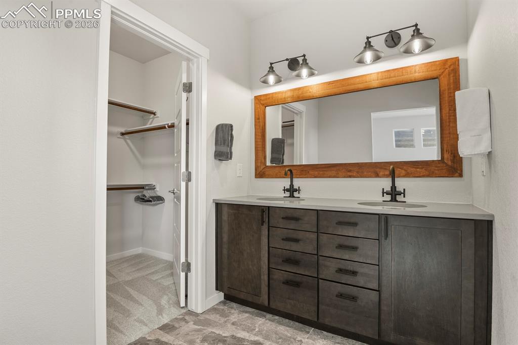 11314 Modern Meadow Loop Colorado Springs, CO 80921 - Photo 18 of 30 a bathroom with a sink and a mirror