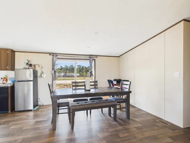 a view of a dining room with furniture and a window