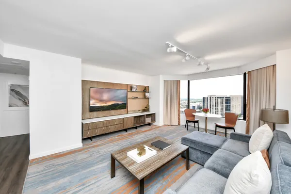 a living room with furniture and a wooden floor