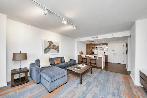 a living room with furniture and wooden floor