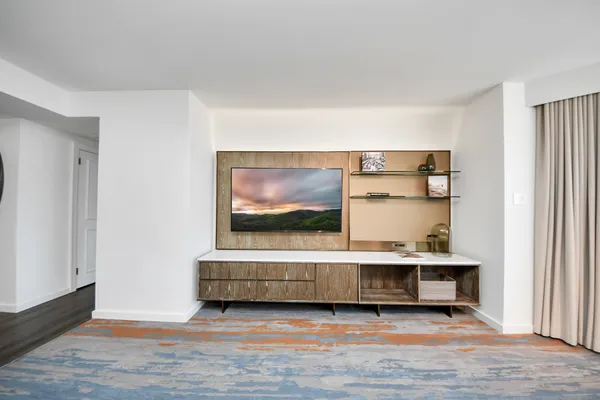 a view of a hallway with wooden floor and staircase