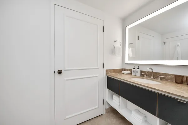 a bathroom with a toilet a sink and shower