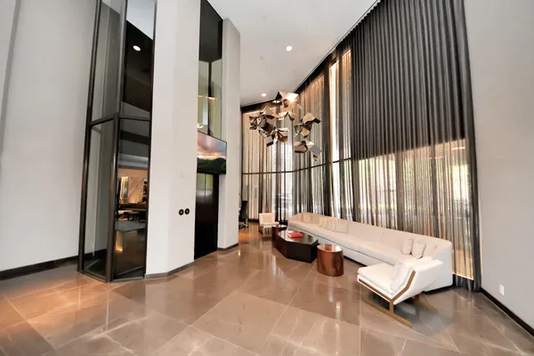 a lobby with furniture and floor to ceiling window