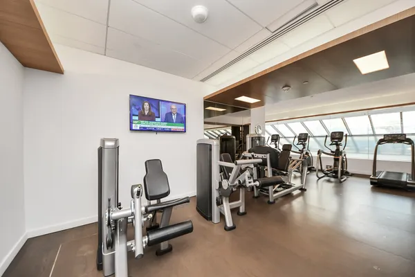 a large building with swimming pool in front of it