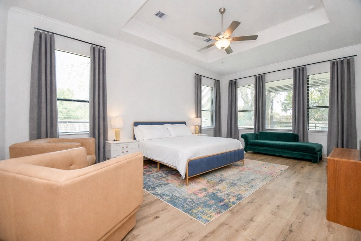 5315 Jason Street Houston, TX 77096 - Photo 19 of 39 a bedroom with a bed a couch and a chandelier