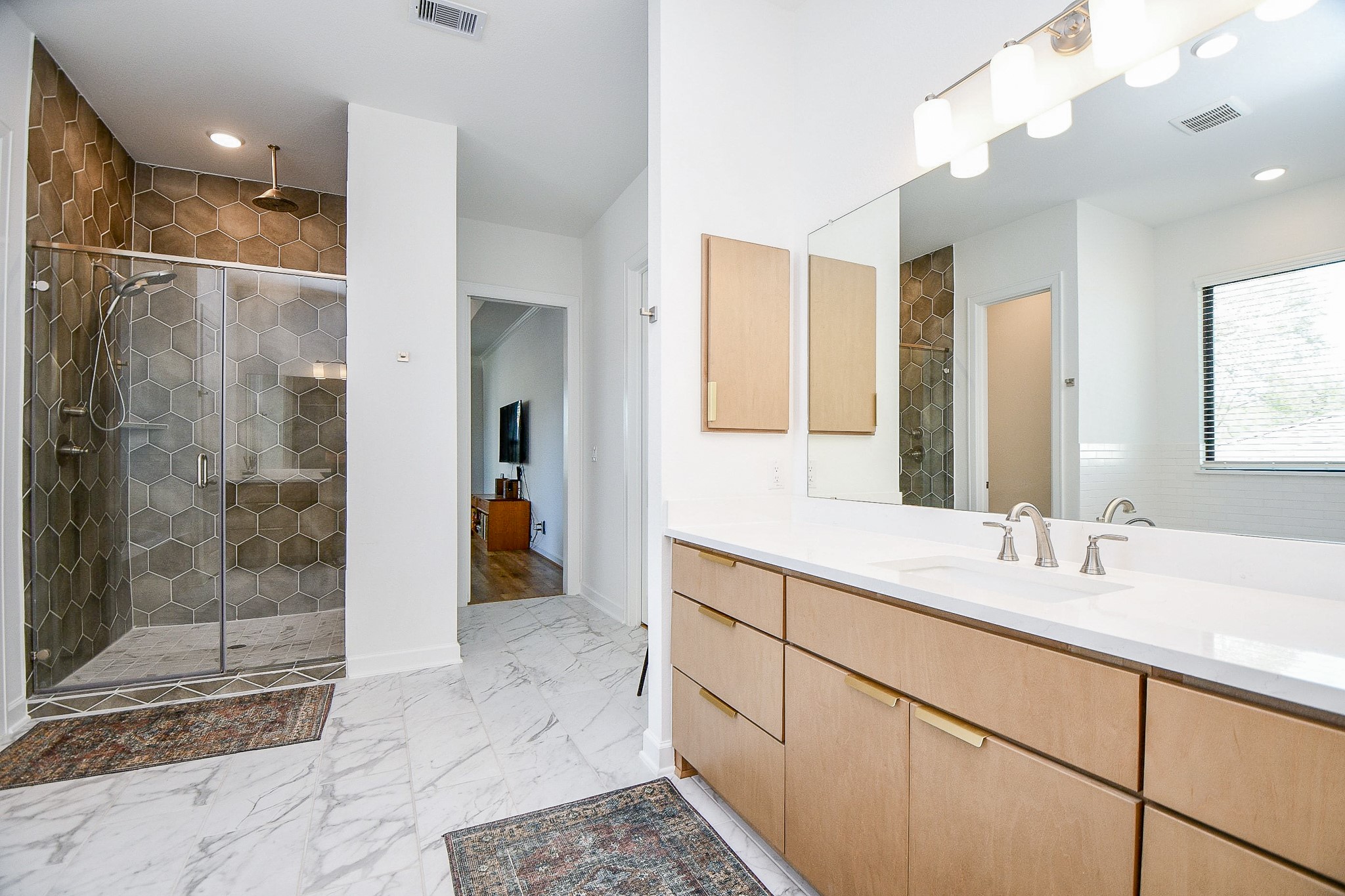5315 Jason Street Houston, TX 77096 - Photo 20 of 39 Spacious primary bath with walk-in shower, light wood cabinetry, long countertop, and clean, modern finishes.