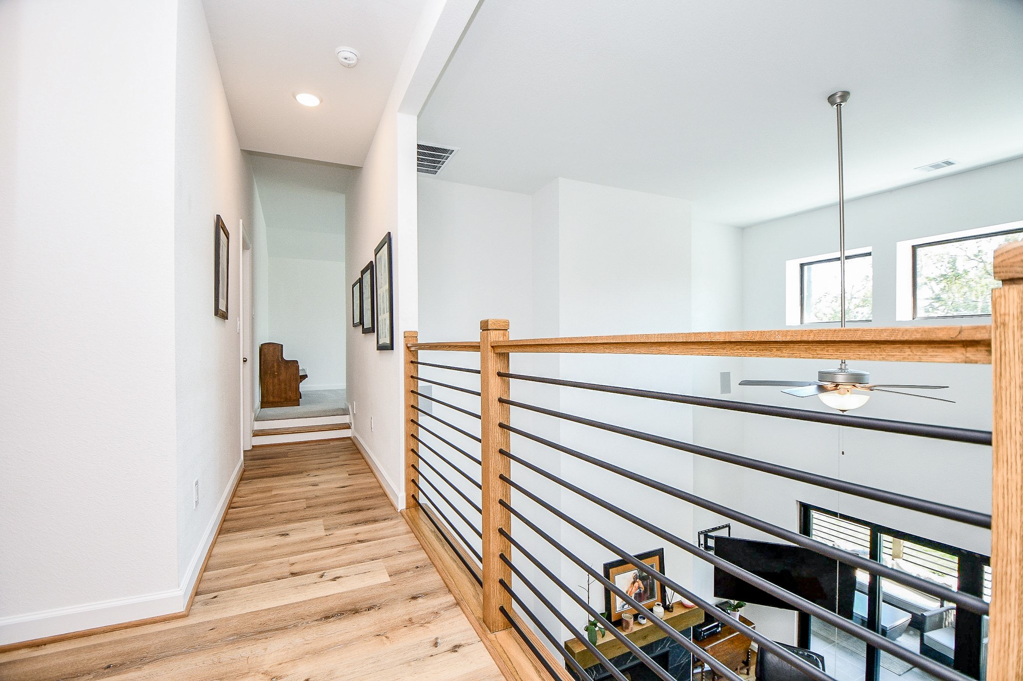 5315 Jason Street Houston, TX 77096 - Photo 26 of 39 Beautiful wood and metal accents are present throughout the home, adding a touch of elegance and sophistication to every space. The combination of natural wood tones and gleaming metal creates a warm and inviting atmosphere, enhancing the overall aesthetic appeal of the property. Gameroom at the end of the hallway.