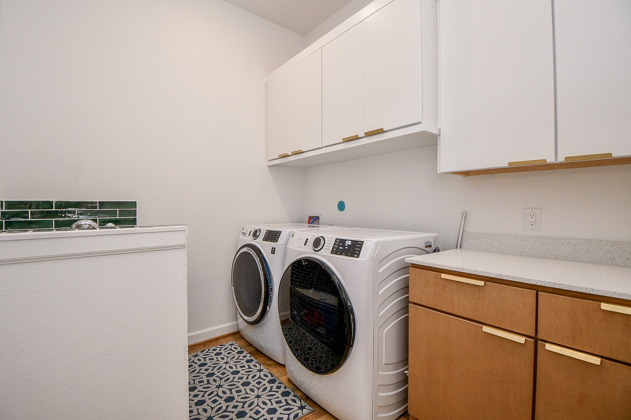 5315 Jason Street Houston, TX 77096 - Photo 33 of 39 The sleek utility room echoes the modern theme of the home with plenty of room for dual laundry appliances, and plenty of welcomed wall storage above and below.
