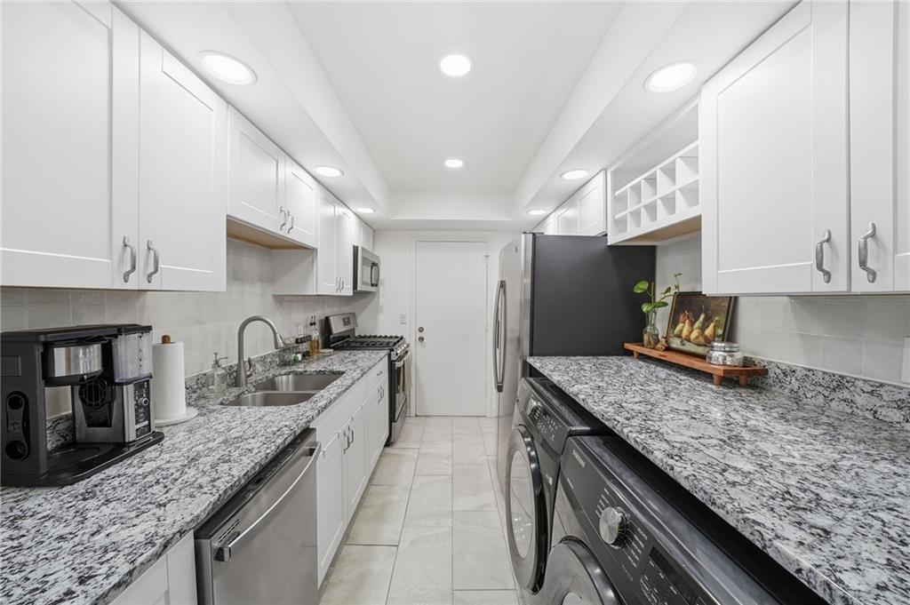 6851 Roswell Road, Unit H29 Atlanta, GA 30328 - Photo 11 of 50 a kitchen with granite countertop stainless steel appliances lots of counter top space