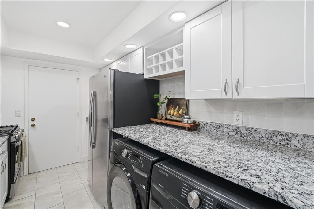 6851 Roswell Road, Unit H29 Atlanta, GA 30328 - Photo 13 of 50 a kitchen with a sink a stove and refrigerator