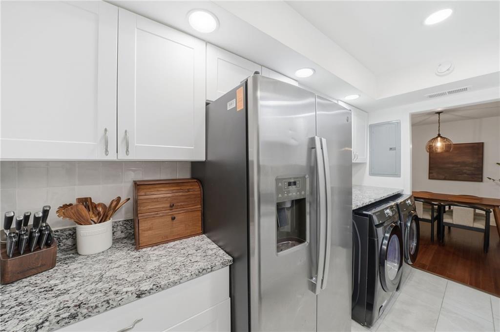 6851 Roswell Road, Unit H29 Atlanta, GA 30328 - Photo 14 of 50 a kitchen with refrigerator and cabinets