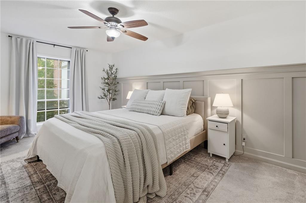 6851 Roswell Road, Unit H29 Atlanta, GA 30328 - Photo 17 of 50 a bedroom with a bed and a chandelier