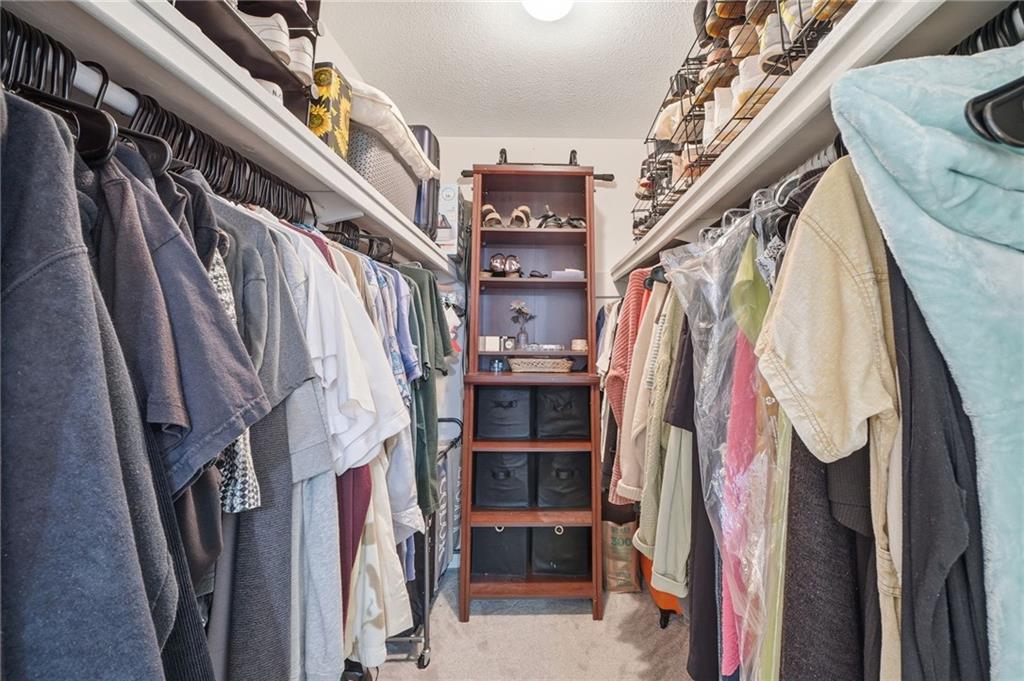 6851 Roswell Road, Unit H29 Atlanta, GA 30328 - Photo 19 of 50 a view of walk in closet with clothes and shoes