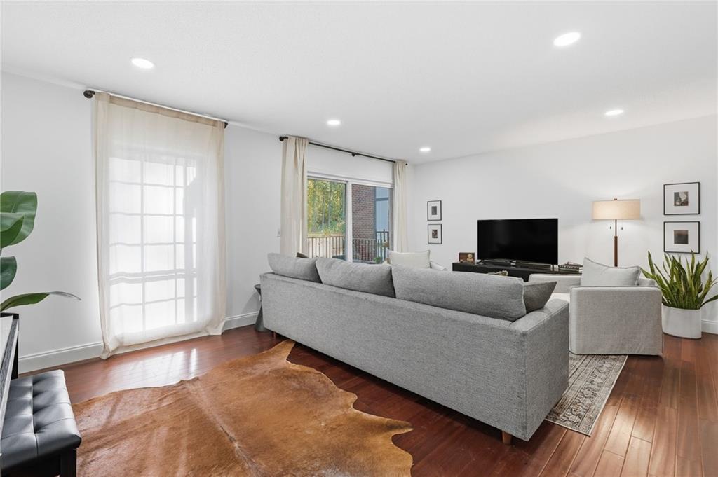 6851 Roswell Road, Unit H29 Atlanta, GA 30328 - Photo 5 of 50 a living room with furniture and a flat screen tv