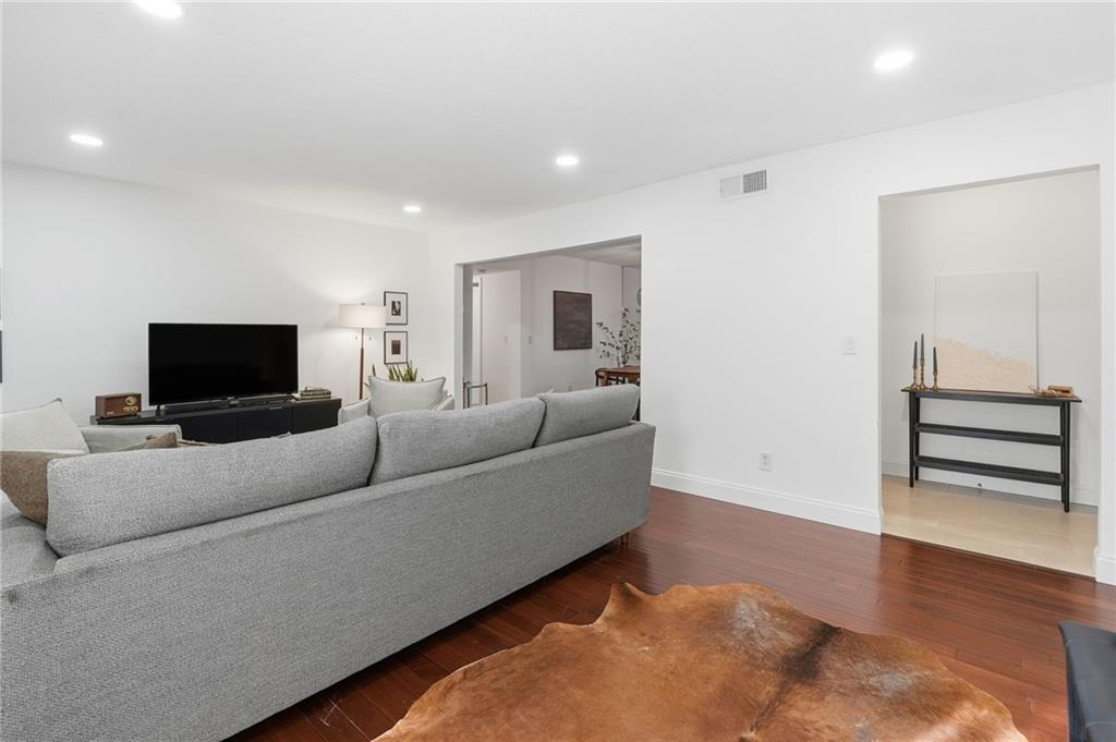 6851 Roswell Road, Unit H29 Atlanta, GA 30328 - Photo 6 of 50 a living room with furniture and a flat screen tv